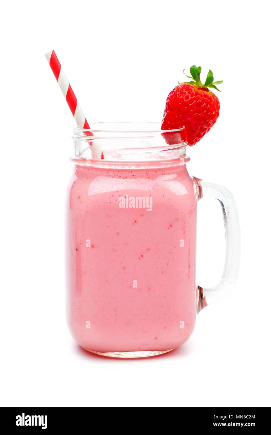 Pink strawberry smoothie in a mason jar glass with straw isolated on white Stock Photo