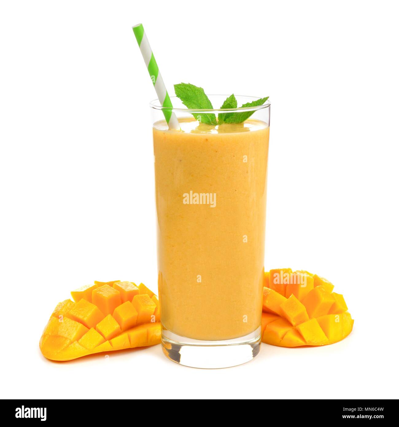 Healthy mango smoothie in a glass with mint and straw isolated on white Stock Photo