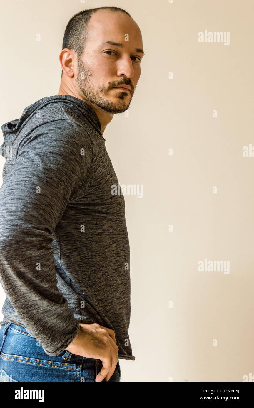 Young man standing front wall hi-res stock photography and images - Alamy