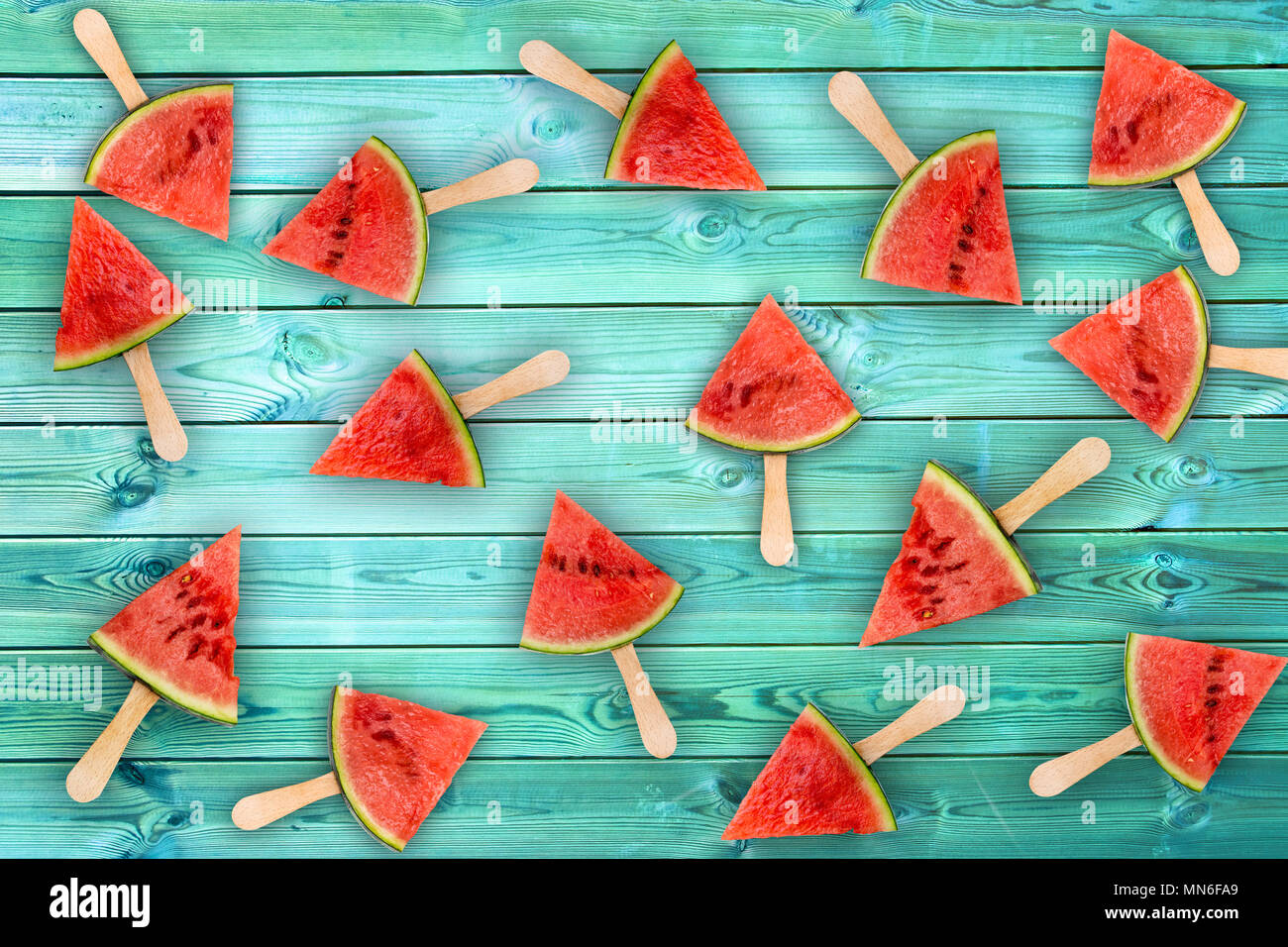 Watermelon slice popsicles on blue wood background, fresh summer fruit concept Stock Photo