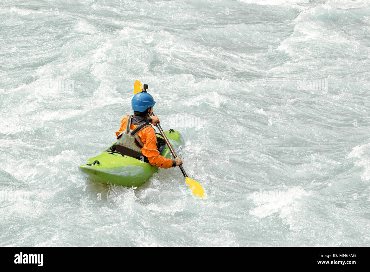 Kayaker paddling in white water rapids,  with copy space Stock Photo