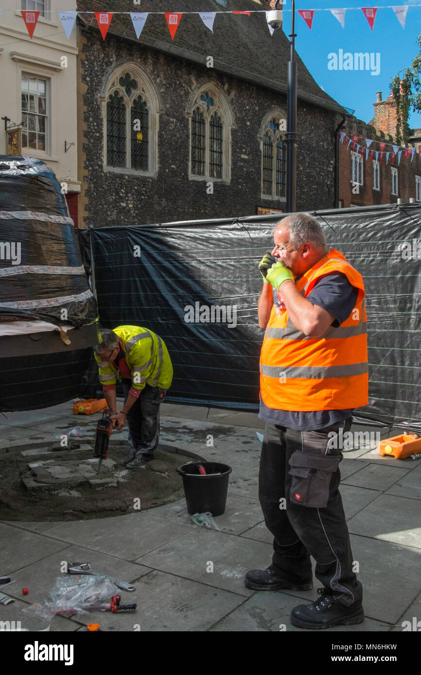 Workmen erecting a statue to the famous English poet Geoffrey Chaucer in Canterbury High Street