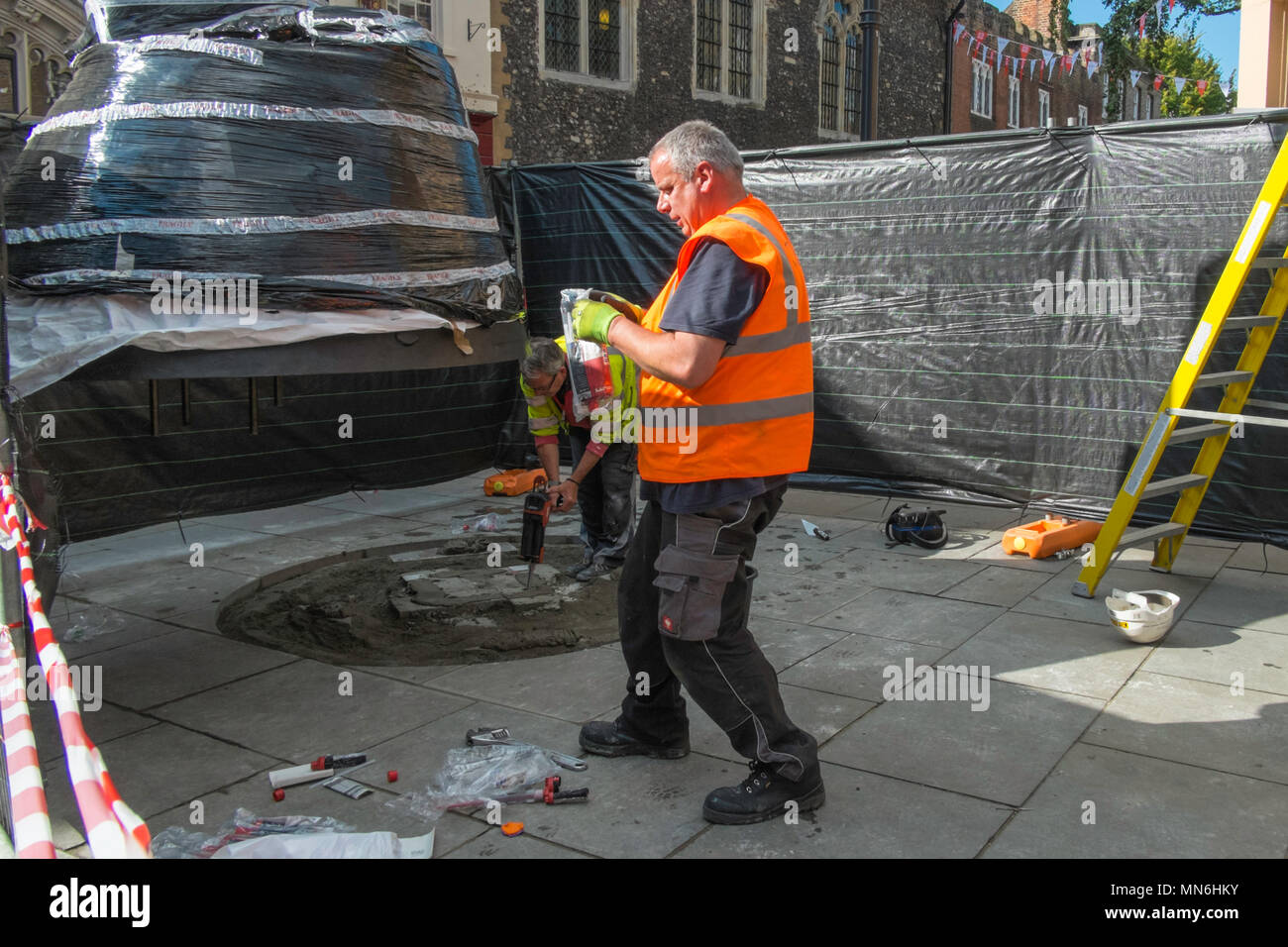 Workmen erecting a statue to the famous English poet Geoffrey Chaucer