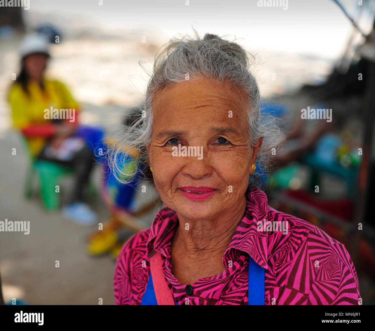 Thai lady managing beach unit providing sun loungers, food and drinks. Pattaya Thailand Stock Photo