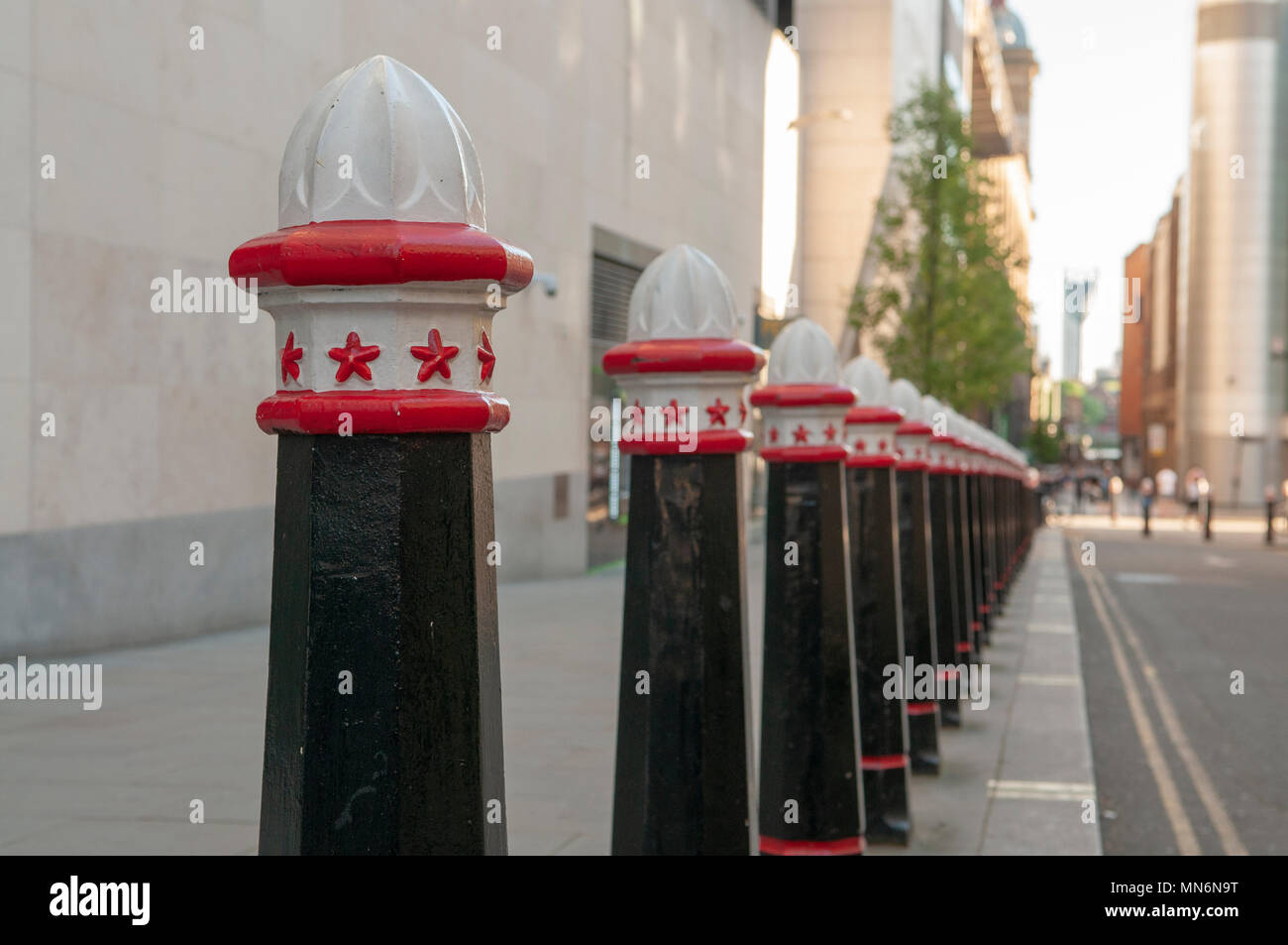 Bollards along a footpath to prevent parking in London. Stock Photo