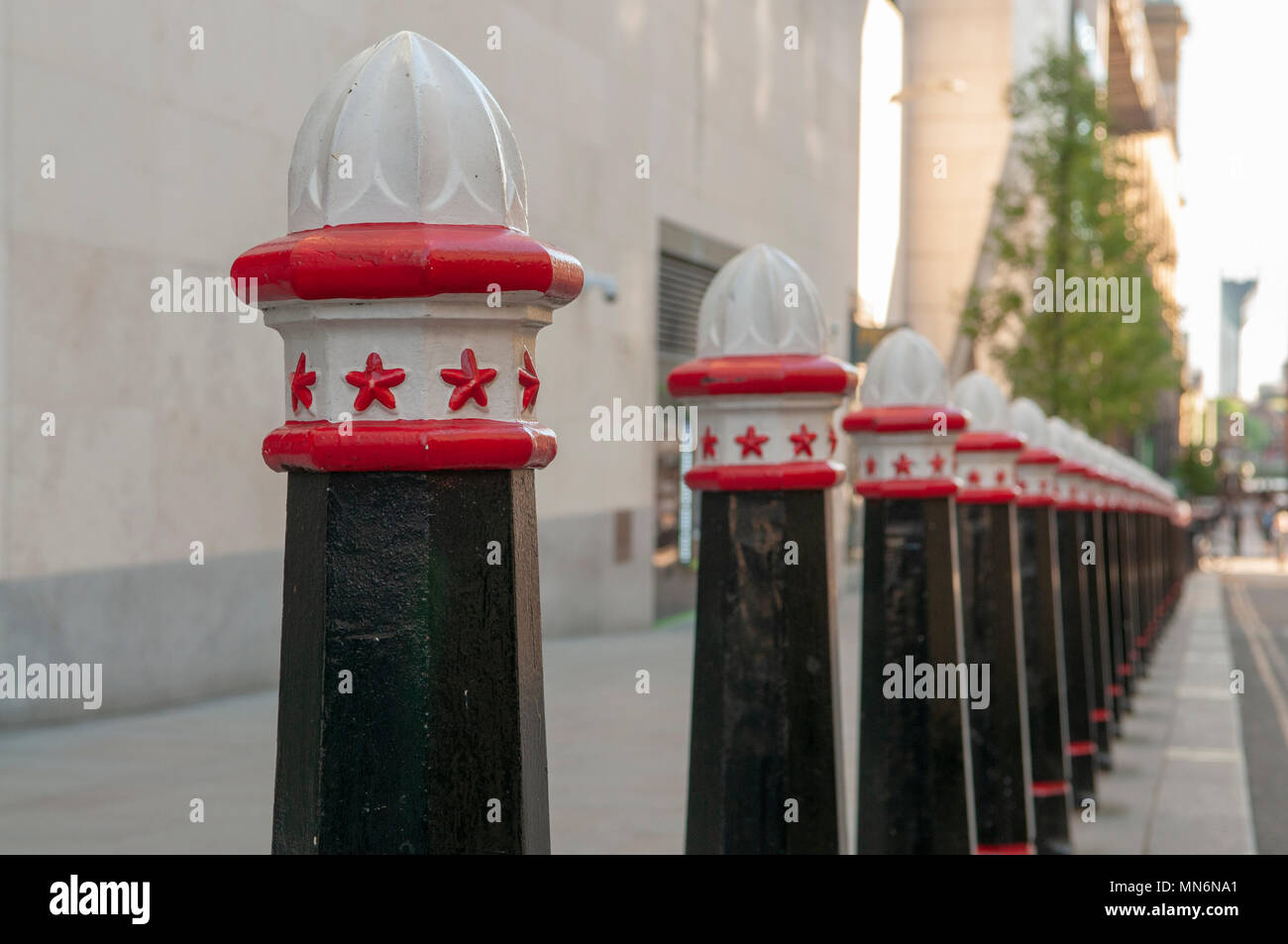 Bollards along a footpath to prevent parking in London. Stock Photo