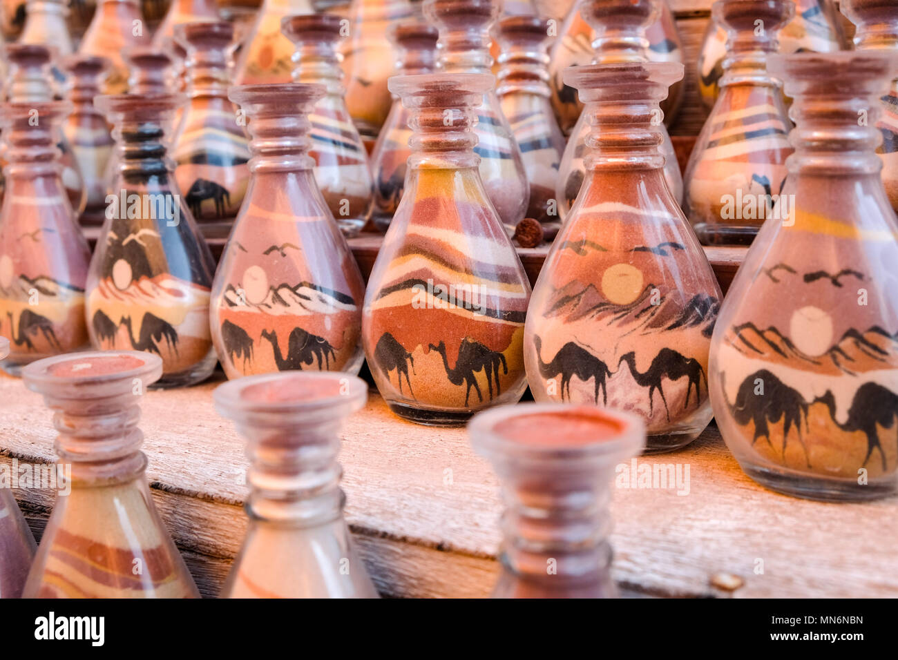 Bottles in a row with sand art for sale in the ancient Nabatean city Stock Photo