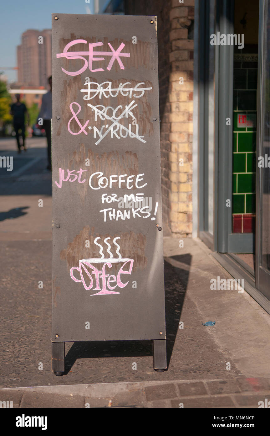 Blackboard outside a coffee shop, saying they don't need sex, drugs or rock-and-roll, just coffee for me thanks. Stock Photo