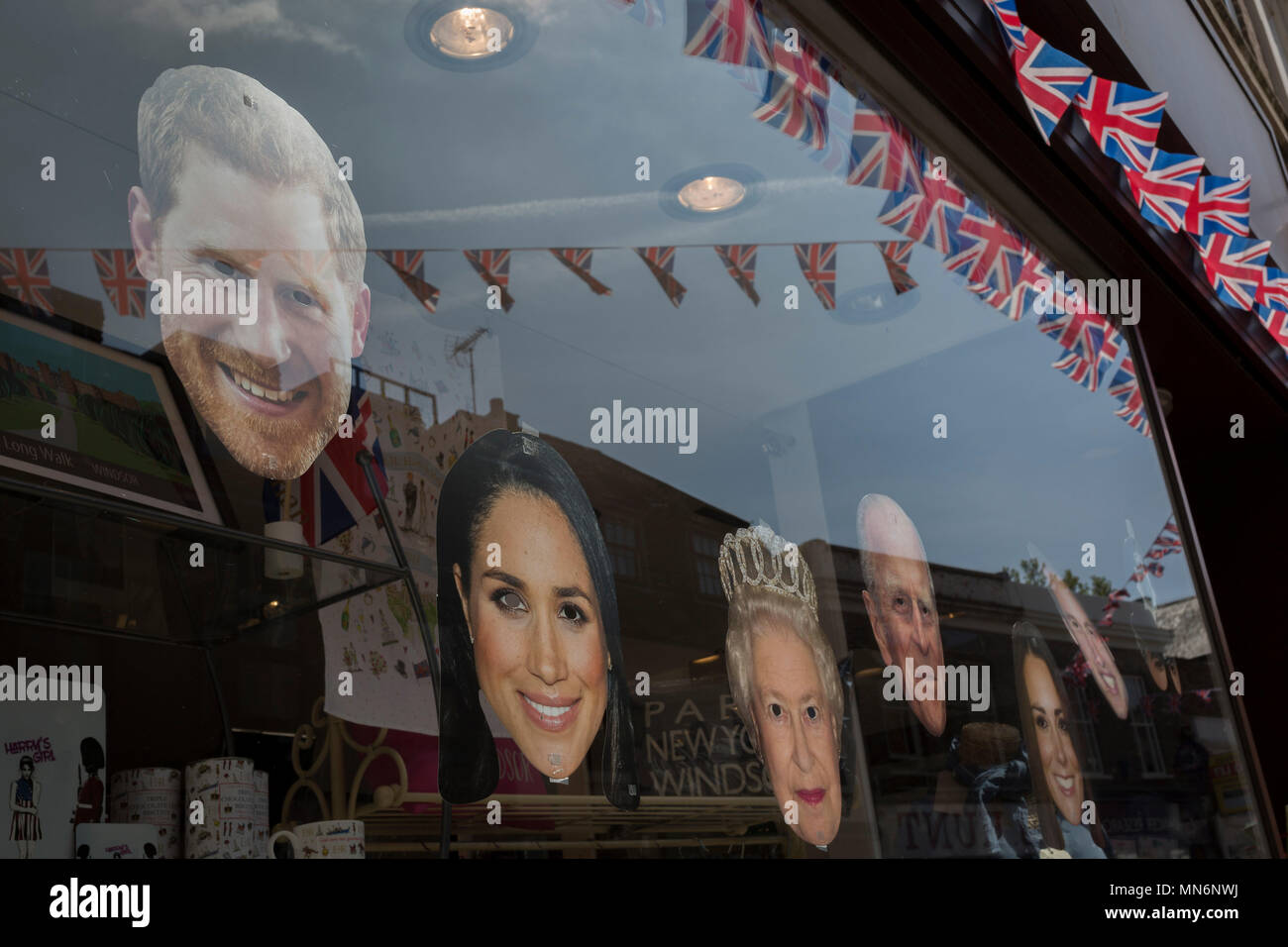 Face masks of the royal family in a shop window as the royal town of Windsor gets ready for the royal wedding between Prince Harry and his American fiance Meghan Markle, on 14th May 2018, in London, England. Stock Photo