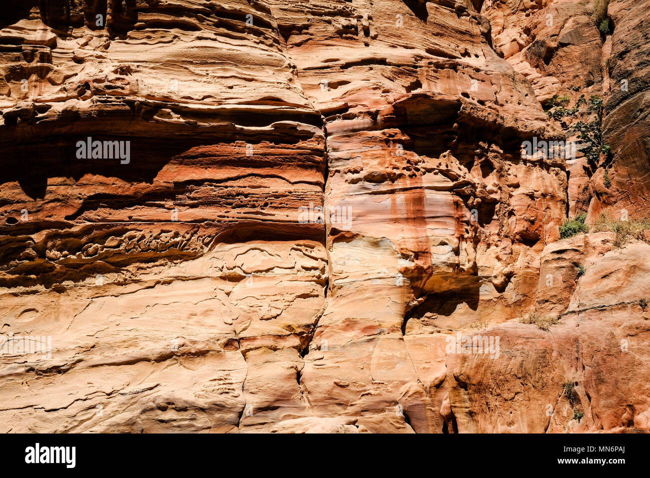 Weathered facade made by colorful sandstone wall eroded in a design in ...