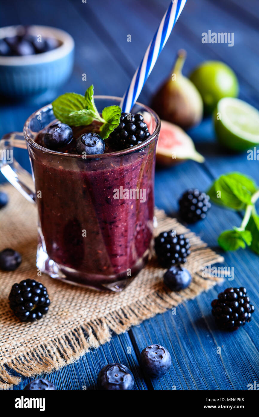 juicy blackberry smoothies in glass bottles Stock Photo by nblxer