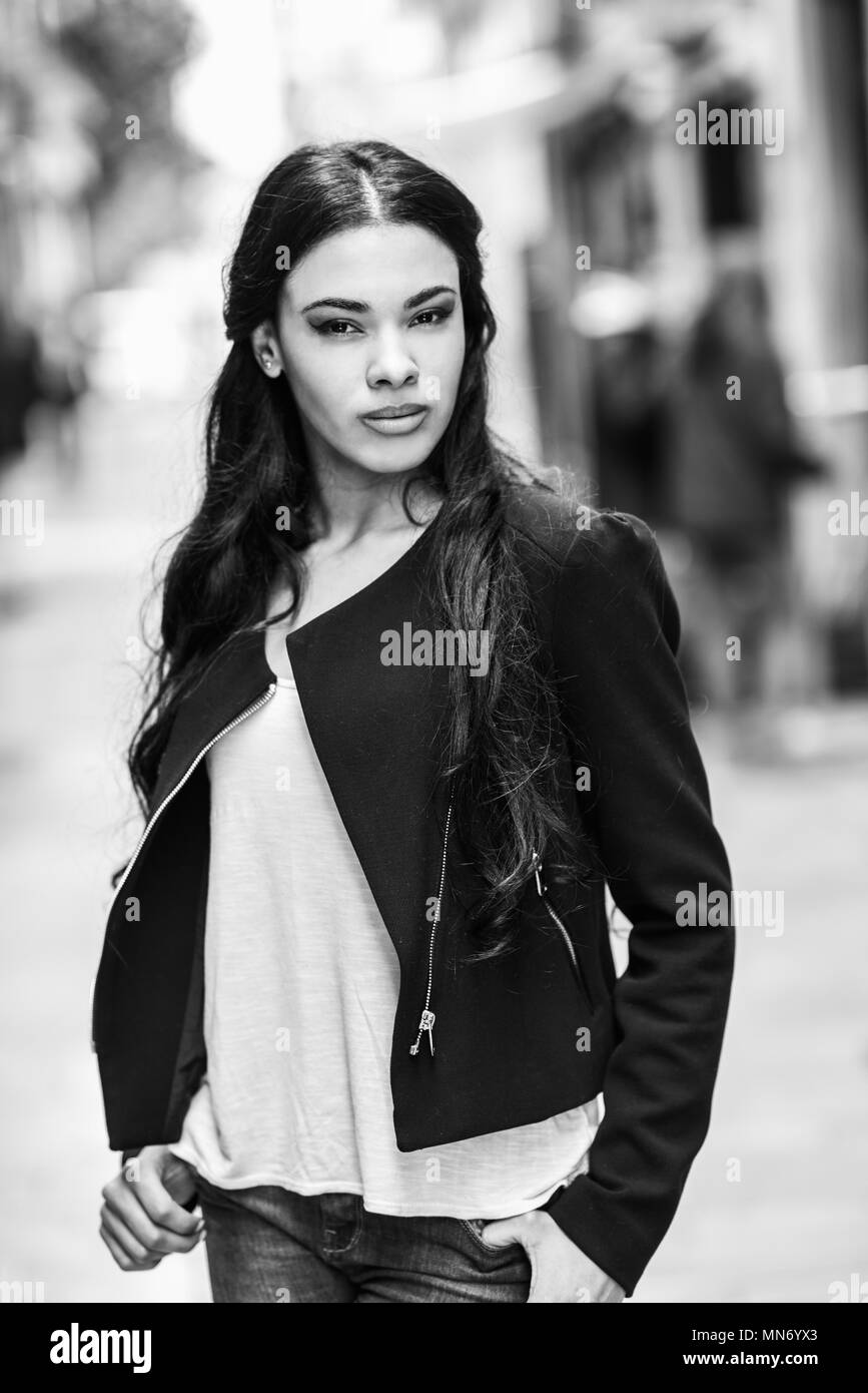Portrait of hispanic young woman wearing casual clothes in urban background Stock Photo