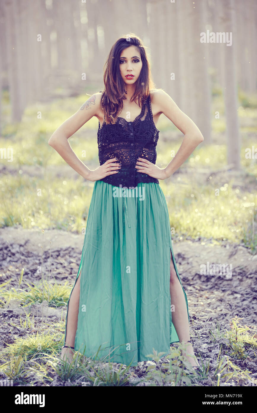 Portrait of beautiful young woman wearing long dress in a forest Stock ...
