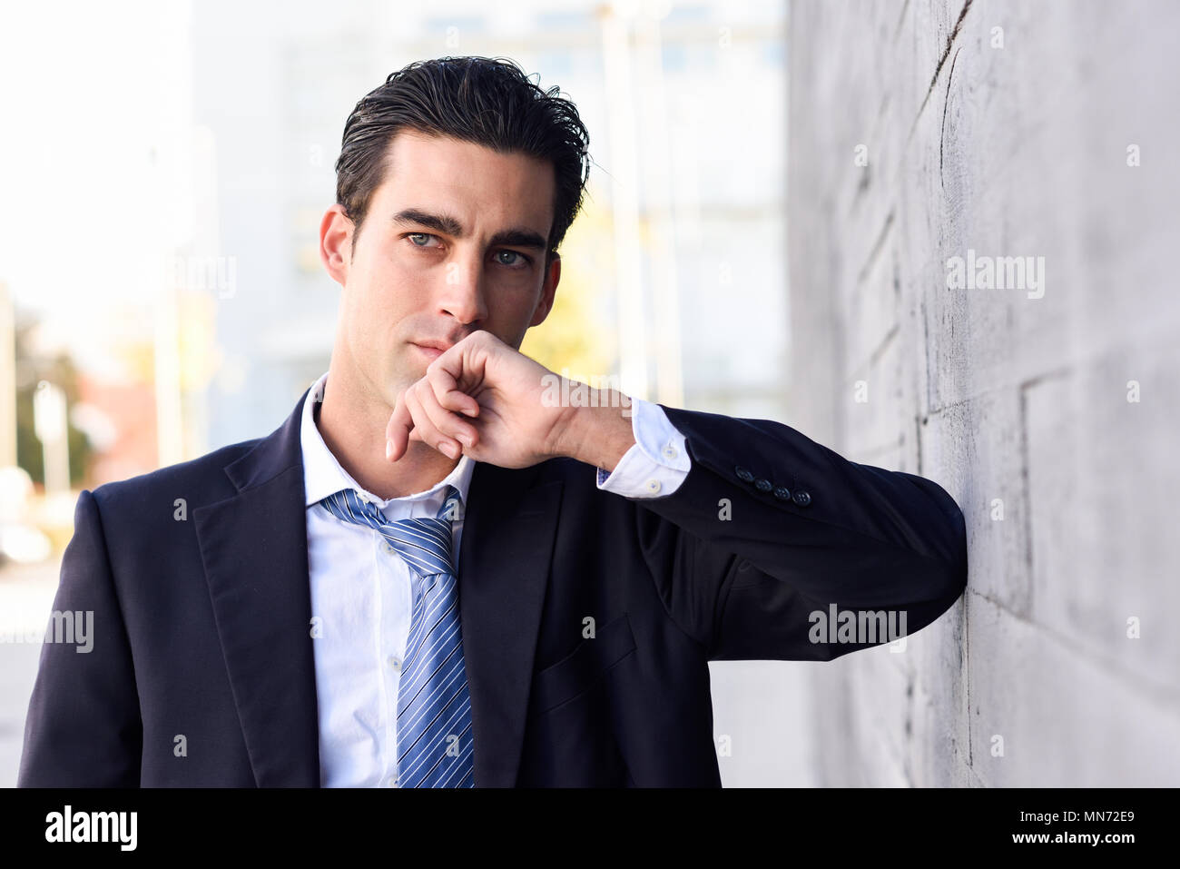 Businessman wearing blue suit and tie in urban background. Man with ...