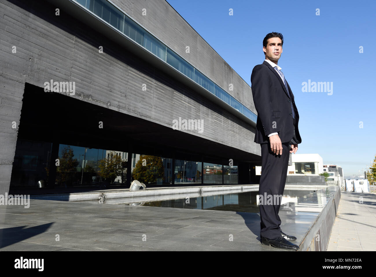 Businessman wearing blue suit and tie in urban background. Man with ...