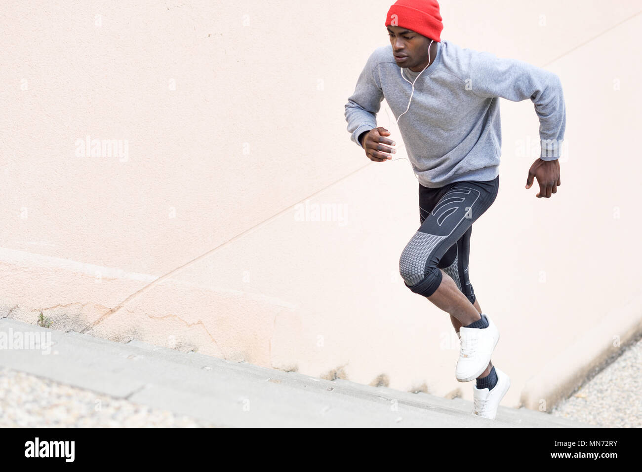 Black man running up stairs hi-res stock photography and images - Alamy