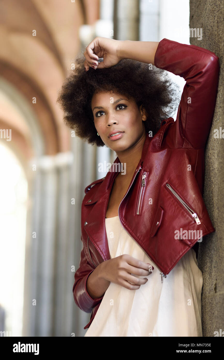 Young Black Female With Afro Hairstyle Standing In An Urban Street