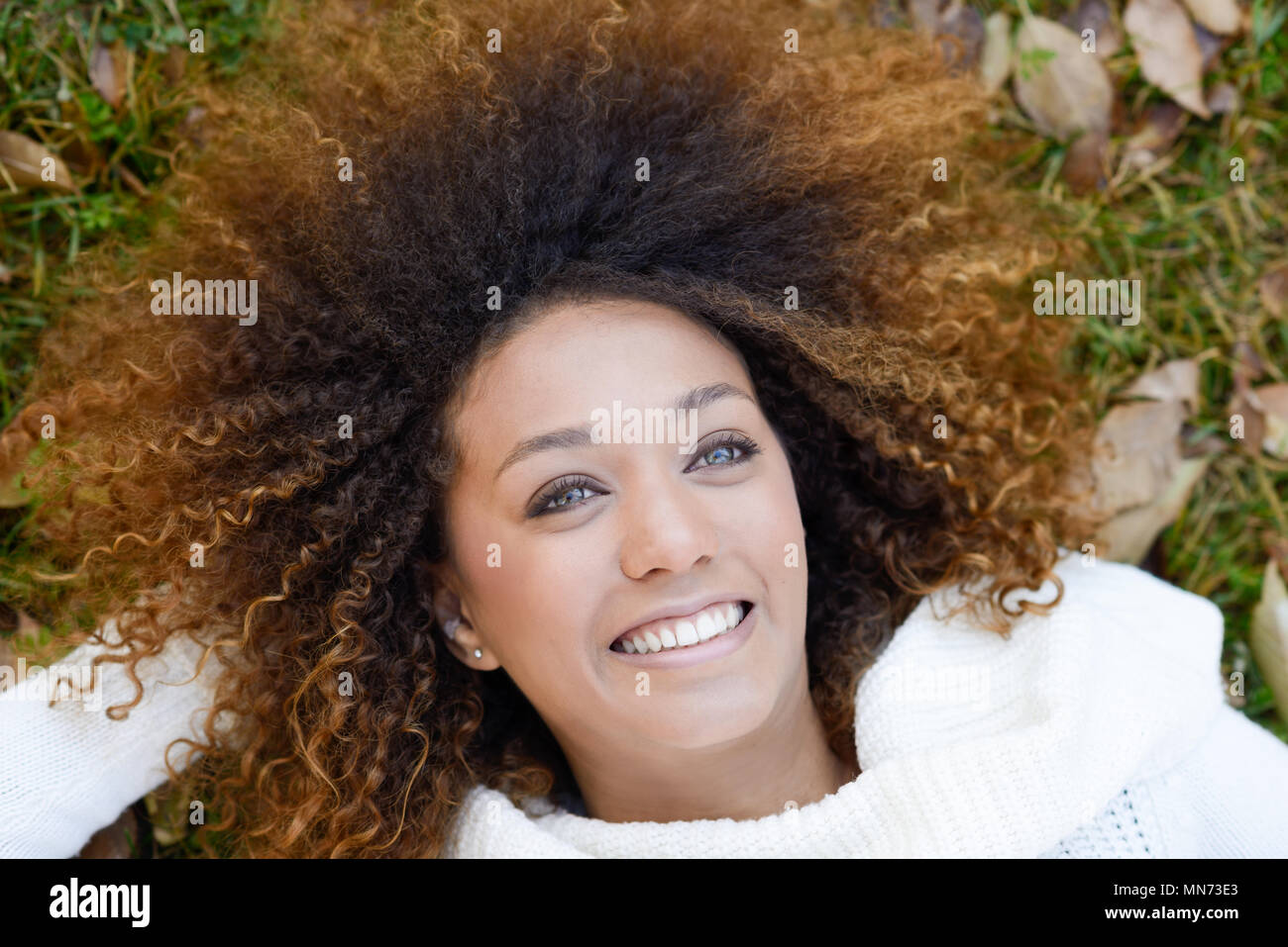 Beautiful young African American woman smiling with afro hairstyle and ...