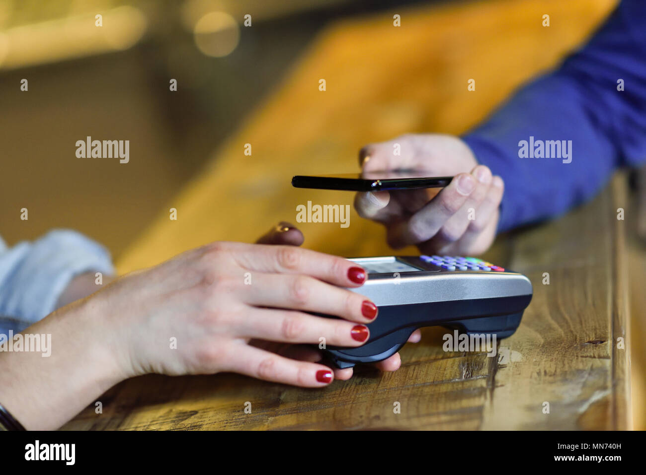 NFC Near Field Communication Mobile Payment. Hand holding smartphone ...