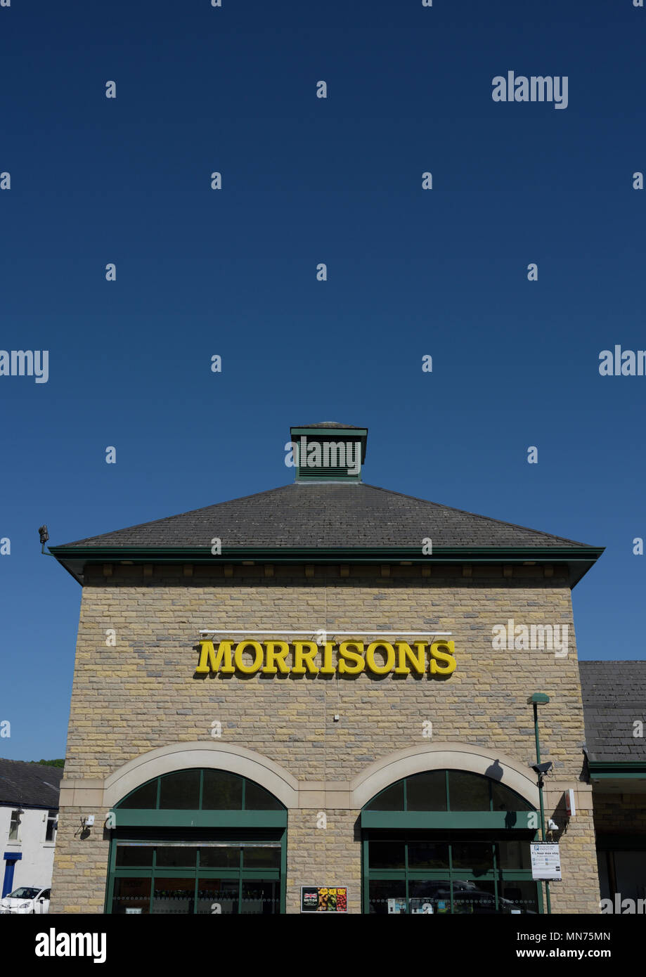Morrisons supermarket with stone wall two stone window arches and slate