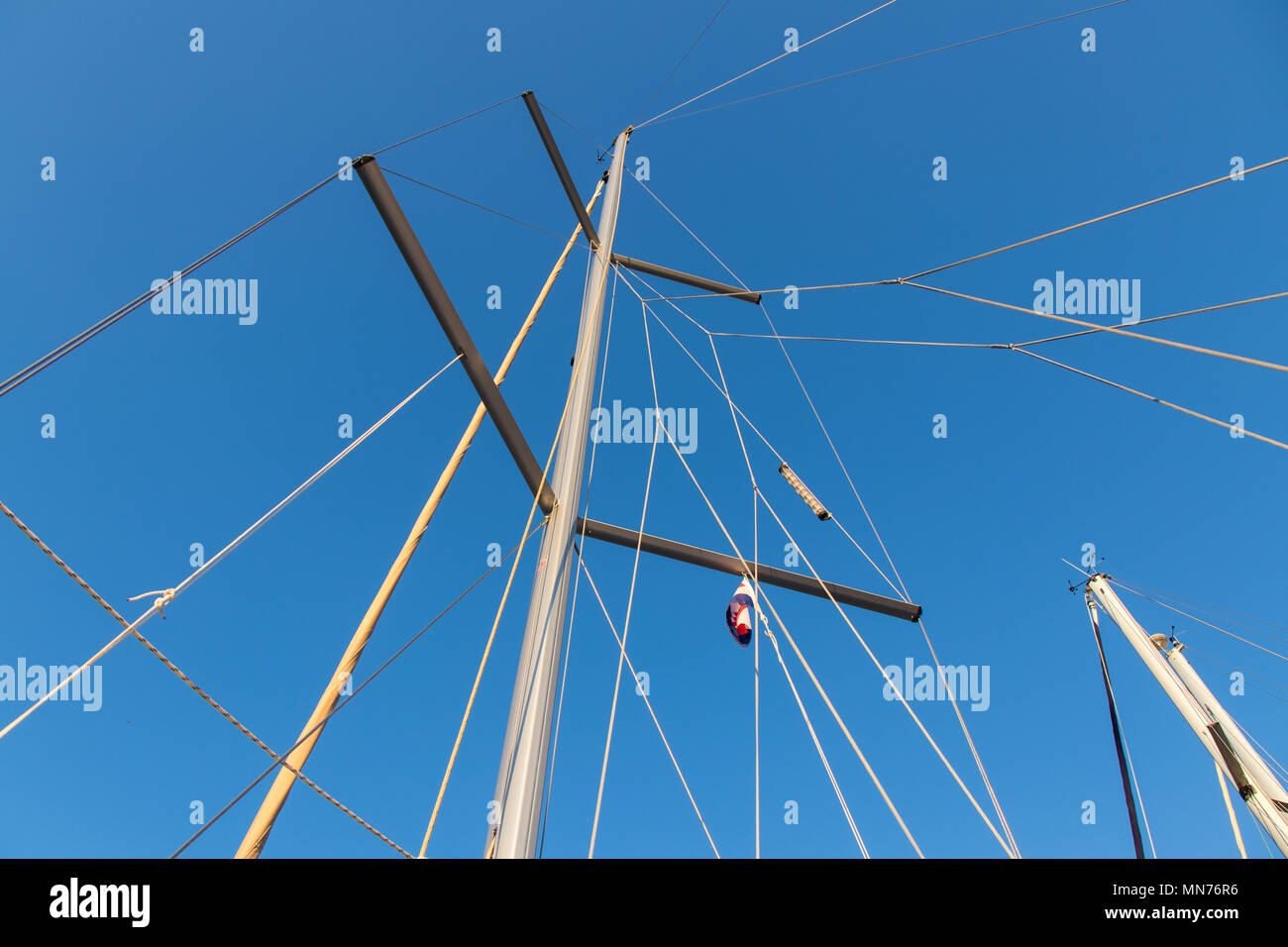 rigging mast and halyards of a sailing boat under a beautiful blue sky