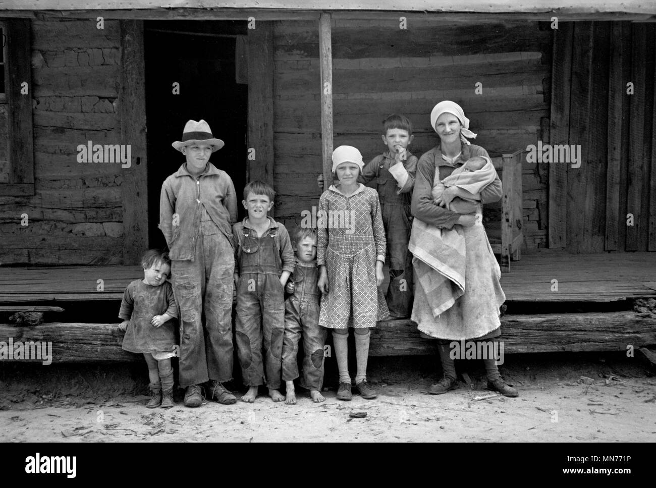 Portrait of Family in Front of Rural Cabin on Natchez Trace Project, near Lexington, Tennessee, USA, Carl Mydans for U.S. Resettlement Administration, March 1936 Stock Photo
