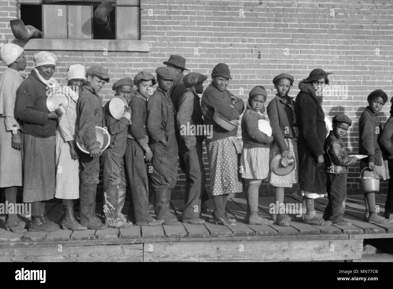 Lined up and Waiting for a Meal in camp for African-American Flood Refugees, Forrest City, Arkansas, USA, Edwin Locke for U.S. Resettlement Administration, February 1937 Stock Photo