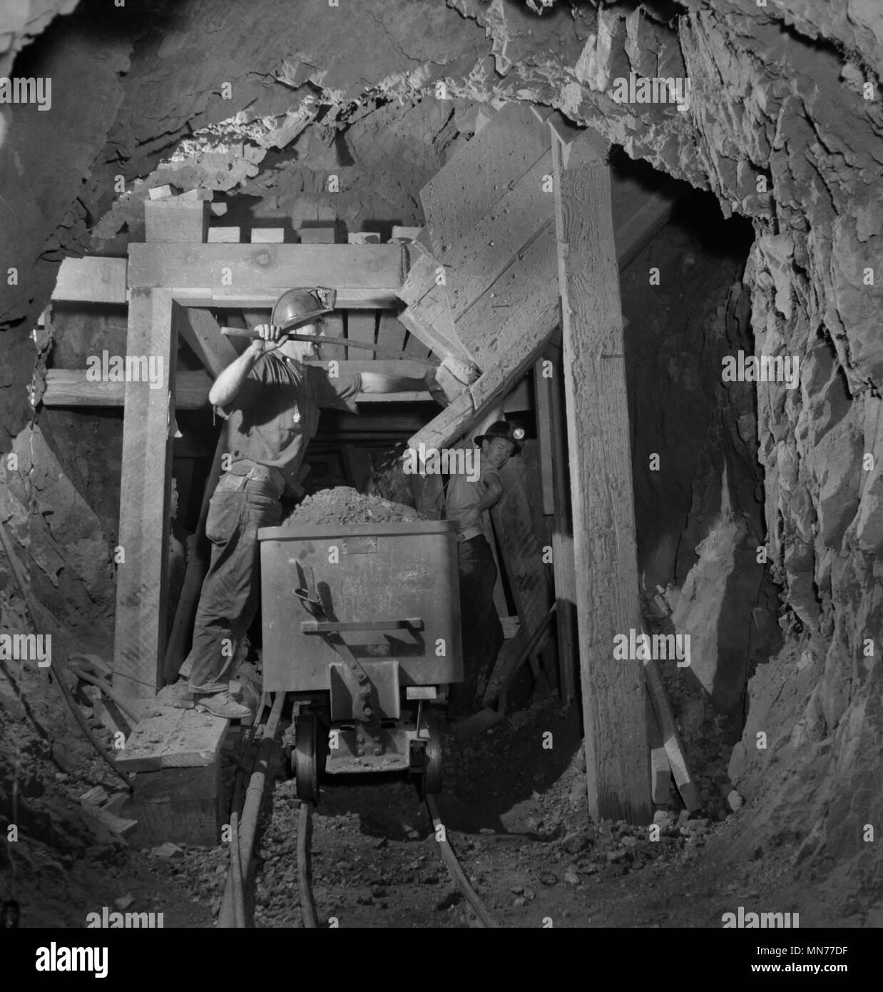 Worker Loading Mercury Ore from Chute into Mine Car, Quicksilver Mining Company, New Idria, California, USA, Andreas Feininger for Office of War Information, December 1942 Stock Photo