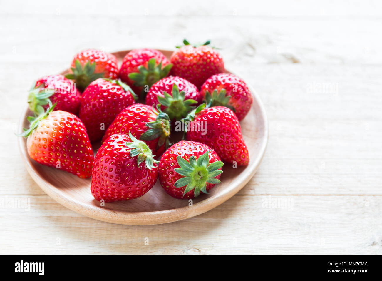 Fresh strawberries in the plate on wooden background Stock Photo - Alamy