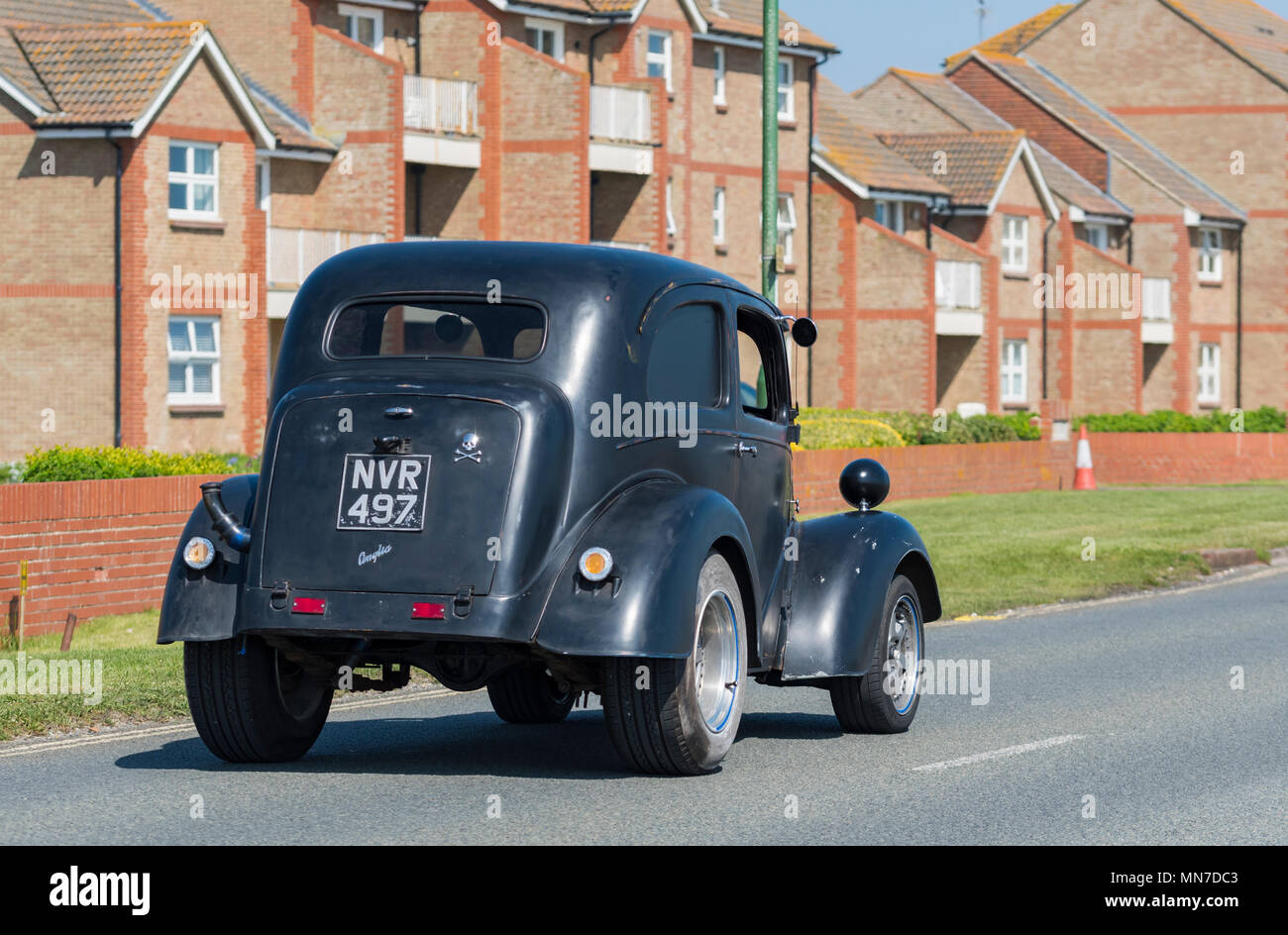 Black vintage Ford Anglia car from 1953, converted to a Hot Rod, in England, UK. Classic car. Stock Photo