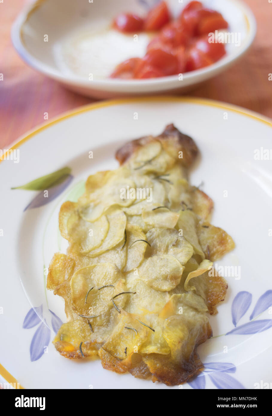 gilthead fillet in potato crust on a set table Stock Photo