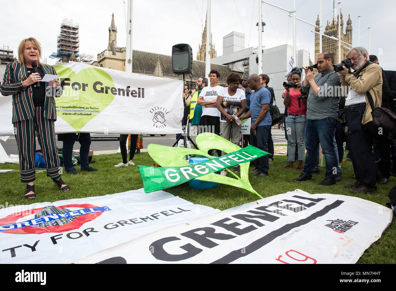 London, UK. 14th May, 2018. Deborah Cole of Inquest addresses Grenfell United Survivors, bereaved families and the community of Grenfell at a rally outside the Houses of Parliament on the 11th anniversary of the fire to urge the Prime Minister to accept their petition to appoint a panel of decision making experts to sit alongside Sir Martin Moore-Bick in the Grenfell Tower Public Inquiry.  The rally was timed to coincide with the debating of the petition in Parliament. Credit: Mark Kerrison/Alamy Live News Stock Photo