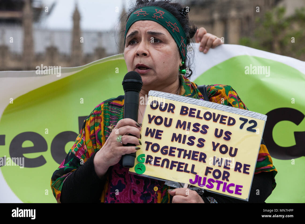 London, UK. 14th May, 2018. A speaker addresses Grenfell United Survivors, bereaved families and the community of Grenfell at a rally outside the Houses of Parliament on the 11th anniversary of the fire to urge the Prime Minister to accept their petition to appoint a panel of decision making experts to sit alongside Sir Martin Moore-Bick in the Grenfell Tower Public Inquiry.  The rally was timed to coincide with the debating of the petition in Parliament. Credit: Mark Kerrison/Alamy Live News Stock Photo