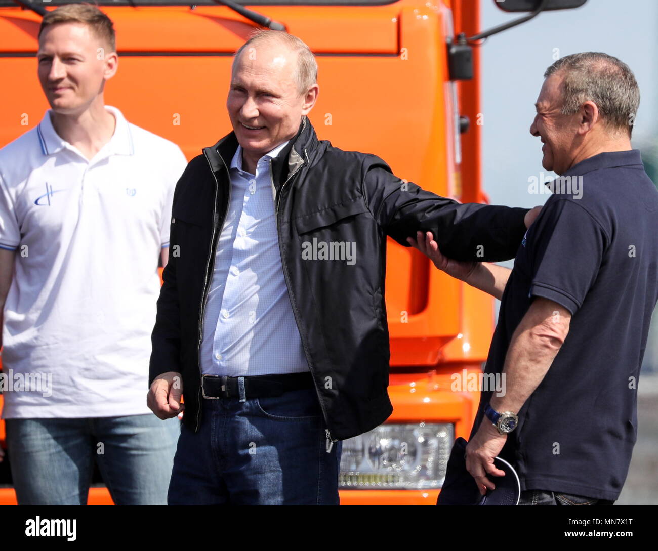 kerch-russia-15th-may-2018-kerch-russia-may-15-2018-russias-president-vladimir-putin-c-and-arkady-rotenberg-r-chairman-of-the-board-of-directors-at-smp-bank-seen-by-the-lead-vehicle-a-kamaz-truck-after-a-passage-of-construction-machines-over-the-kerch-strait-crimean-bridge-the-road-rail-bridge-across-the-kerch-strait-linking-crimea-to-mainland-russia-will-open-to-automobile-traffic-in-both-directions-on-may-16-2018-sergei-bobylevtass-credit-itar-tass-news-agencyalamy-live-news-MN7X1T.jpg