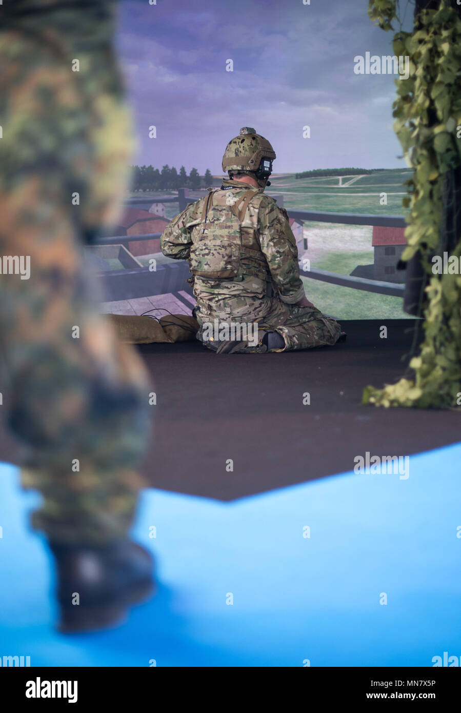 Stuttgart, Germany. 15th May, 2018. 15 May 2018, Germany, Stuttgart: An extra uses a simulation programme by the company Holovis on the first day of the ITEC fair for military and weapons technology. The fair, which presents training and simulation software, among others, is running from 15 to 17 May. It is accompanied by demonstrations by opponents of weaponry. Photo: Sebastian Gollnow/dpa Credit: dpa picture alliance/Alamy Live News Stock Photo