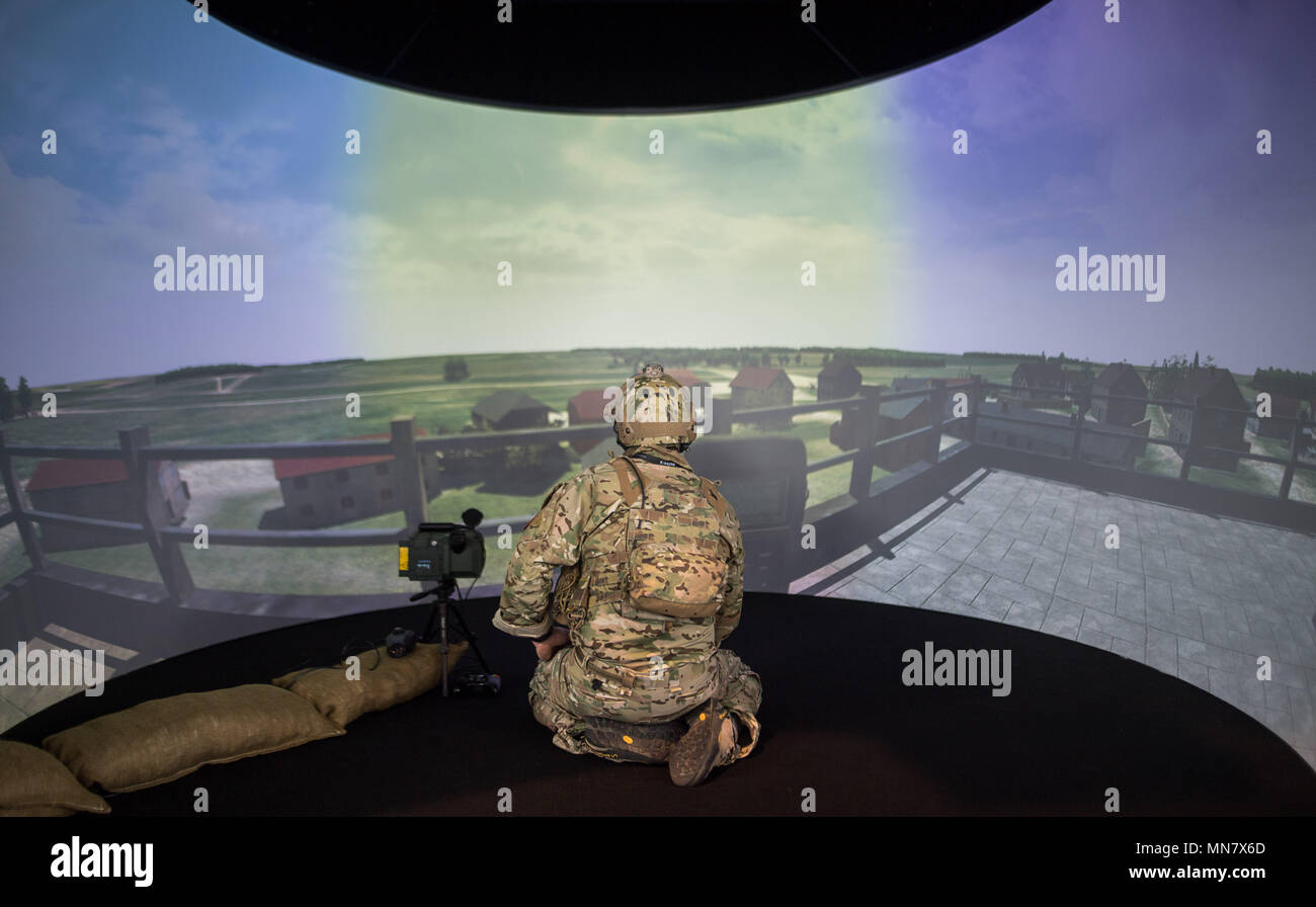 Stuttgart, Germany. 15th May, 2018. 15 May 2018, Germany, Stuttgart: An extra uses a simulation programme by the company Holovis on the first day of the ITEC fair for military and weapons technology. The fair, which presents training and simulation software, among others, is running from 15 to 17 May. It is accompanied by demonstrations by opponents of weaponry. Photo: Sebastian Gollnow/dpa Credit: dpa picture alliance/Alamy Live News Stock Photo