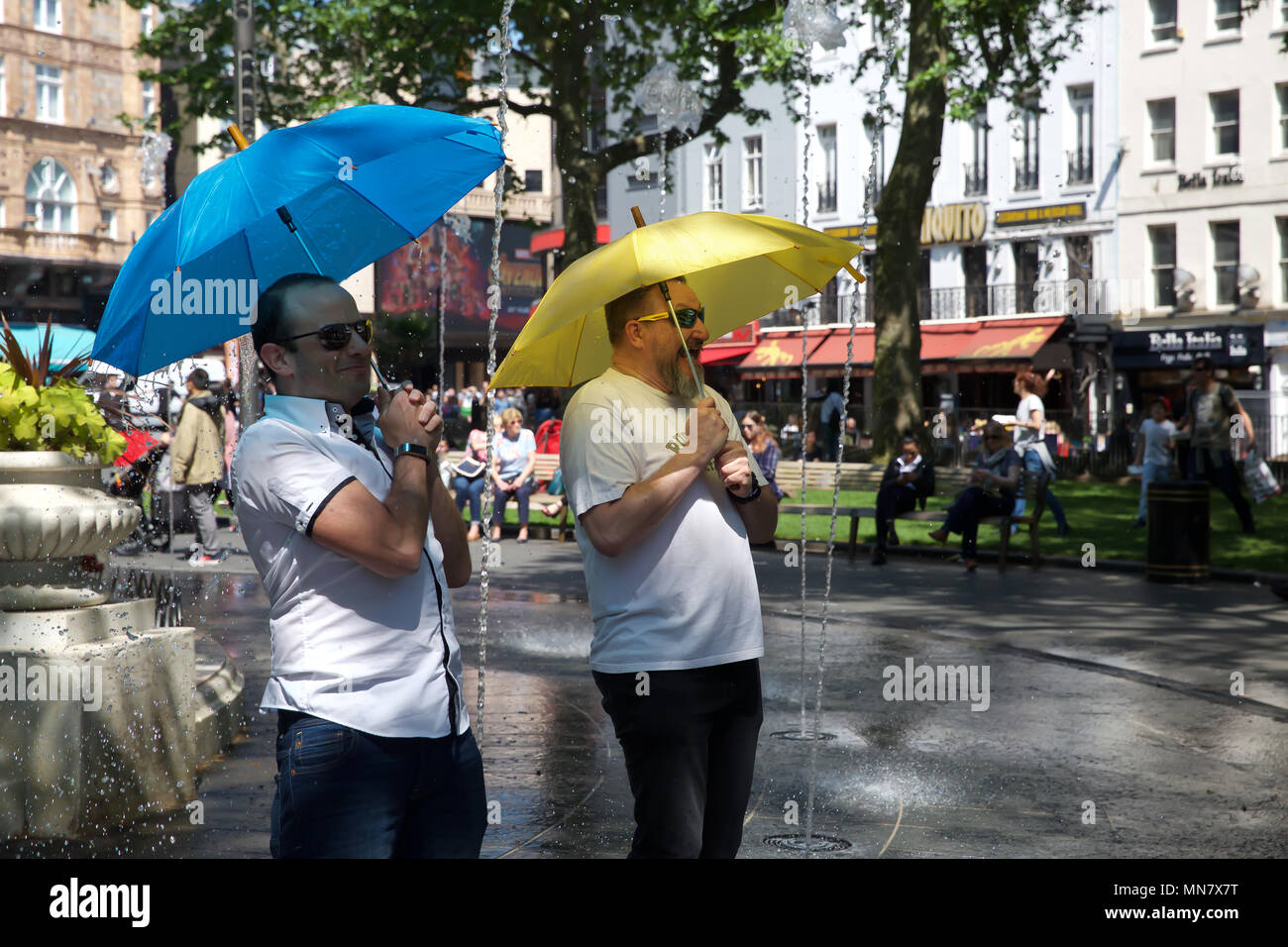 London, UK. 15th May, 2018. People cool off in Water fountains in