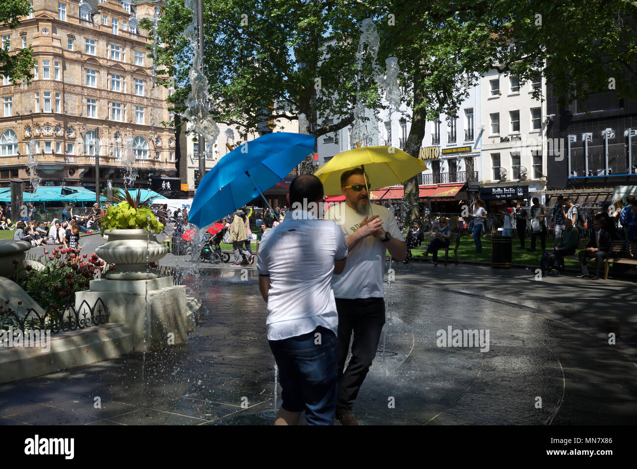 London, UK. 15th May, 2018. People cool off in Water fountains in