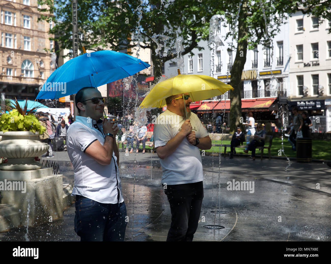 London, UK. 15th May, 2018. People cool off in Water fountains in