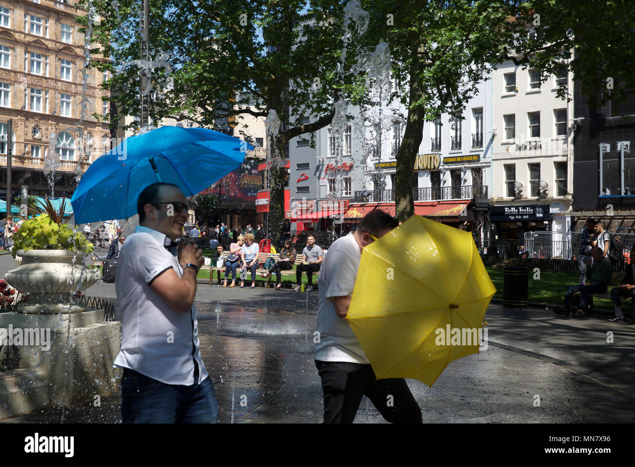 London, UK. 15th May, 2018. People cool off in Water fountains in