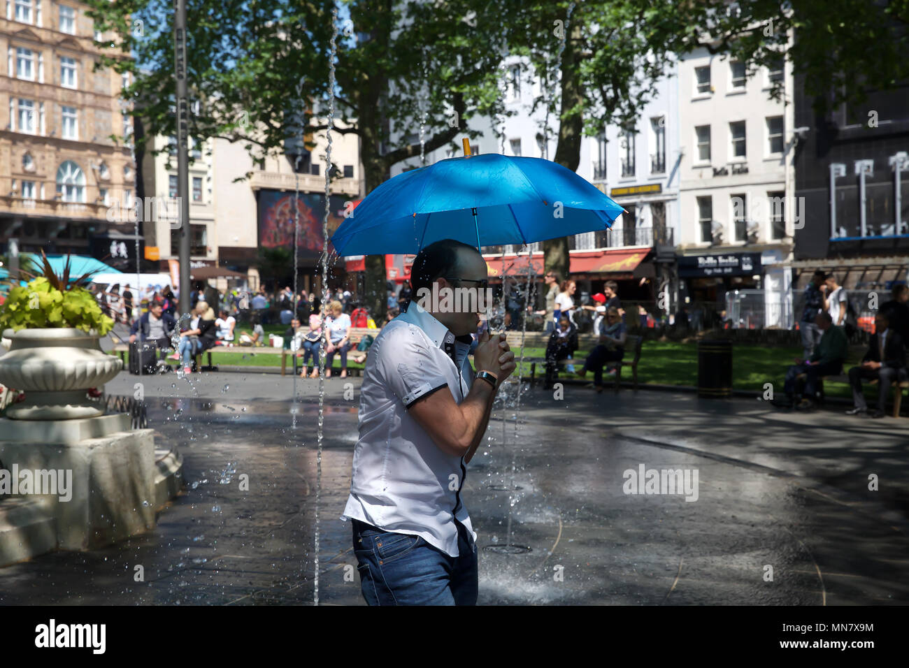 London, UK. 15th May, 2018. People cool off in Water fountains in
