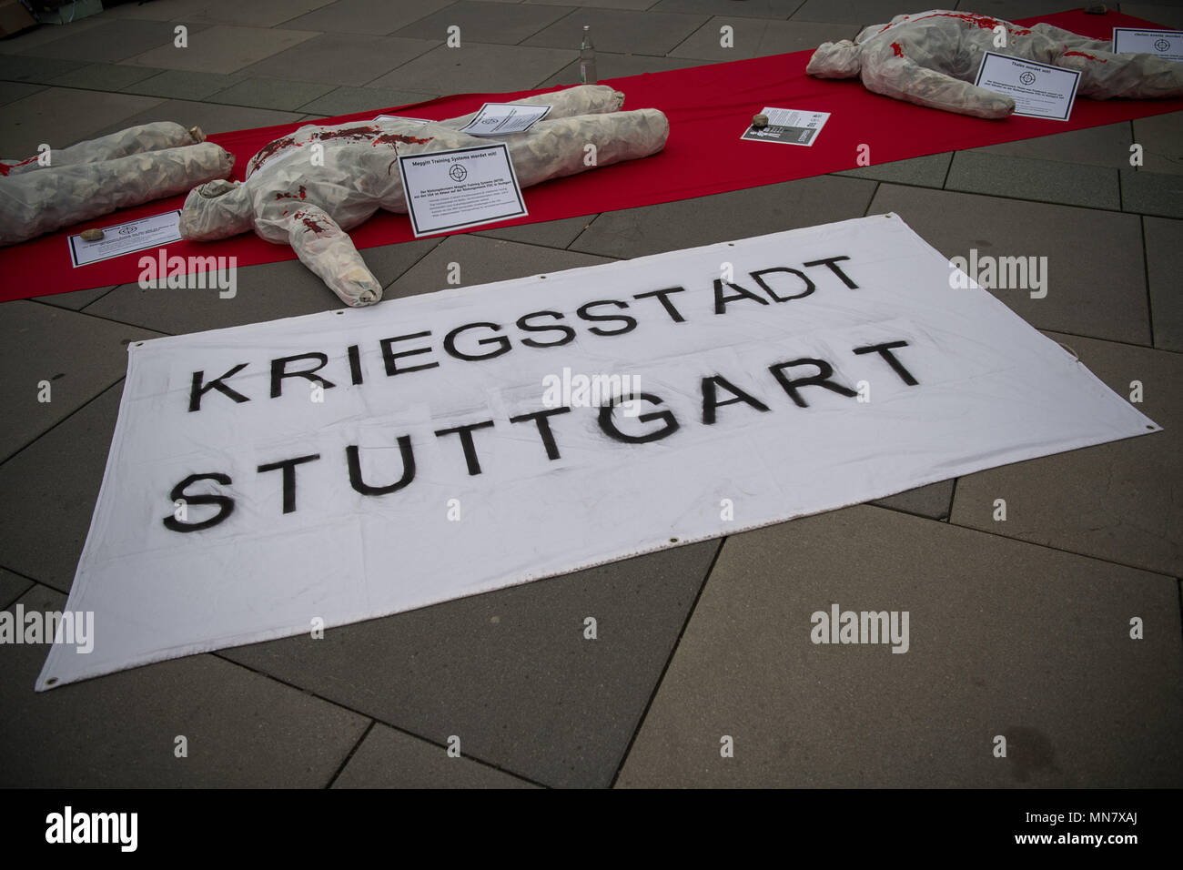 Stuttgart, Germany. 15th May, 2018. 15 May 2018, Germany, Stuttgart: A banner reading 'war city Stuttgar' lying at a protest stand on the first day of the ITEC fair for military and weapons technology. The fair, which presents training and simulation software, among others, is running from 15 to 17 May. It is accompanied by demonstrations by opponents of weaponry. Photo: Sebastian Gollnow/dpa Credit: dpa picture alliance/Alamy Live News Stock Photo