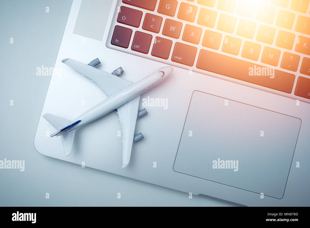 white plane model and computer laptop with sunlight on white background . travel , visa and vacation concept Stock Photo