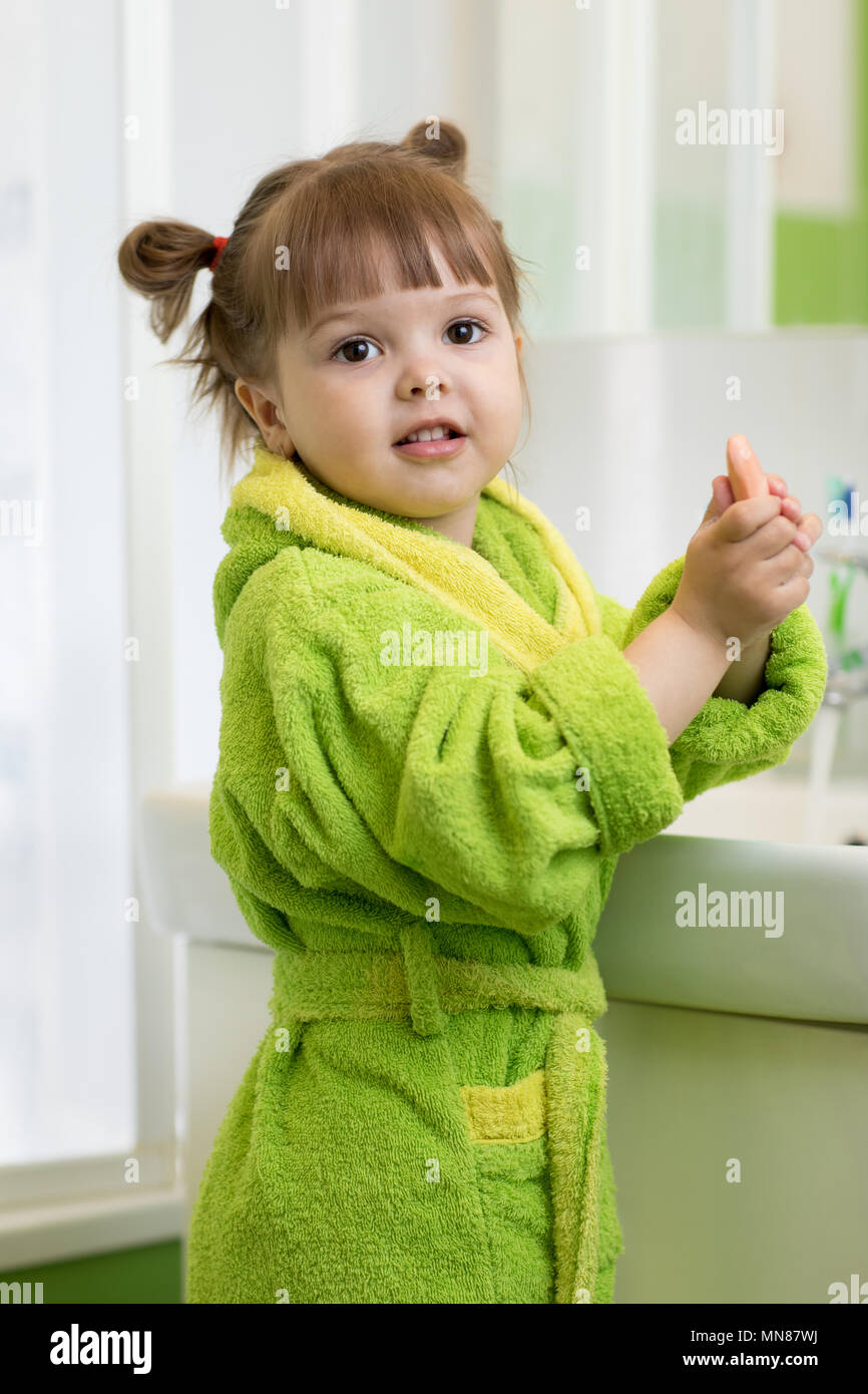 Little girl is washing her hands in the bathroom Stock Photo - Alamy