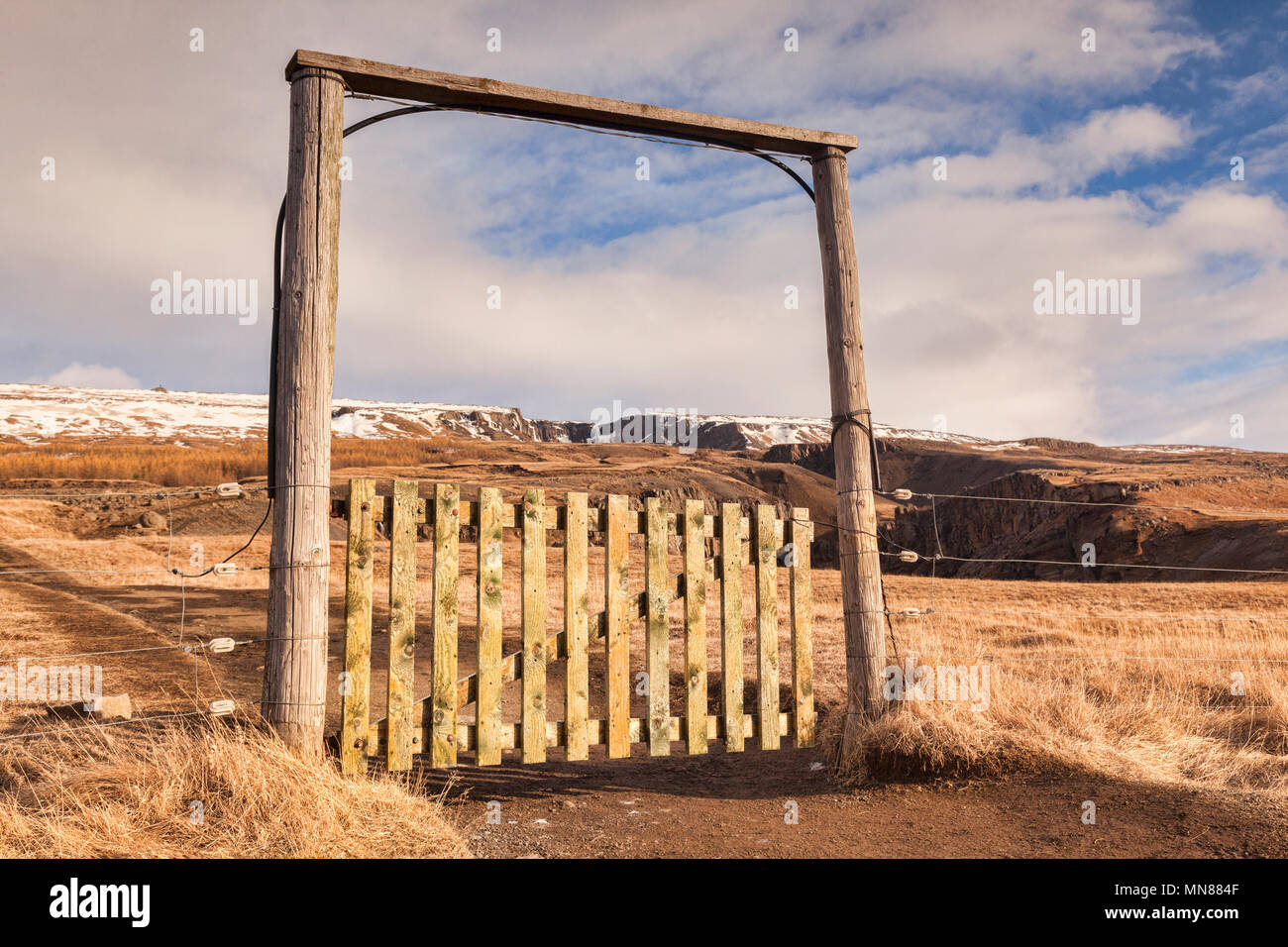 A typical gate through an electric fence on a hiking track in East Iceland. This is the track to Hengifoss, Iceland's second highest waterfall. Stock Photo