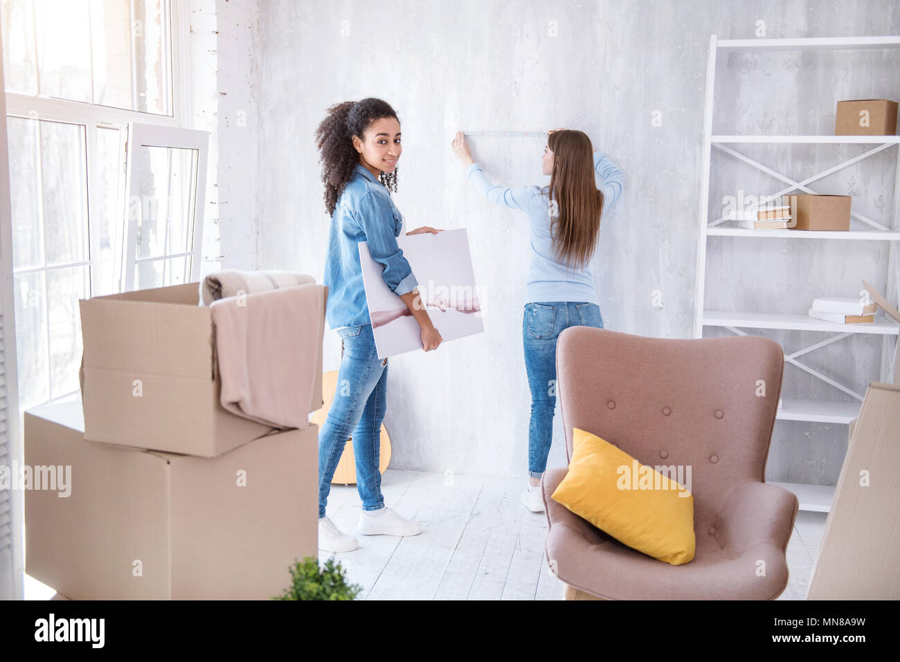 Charming curly girl posing with a picture Stock Photo