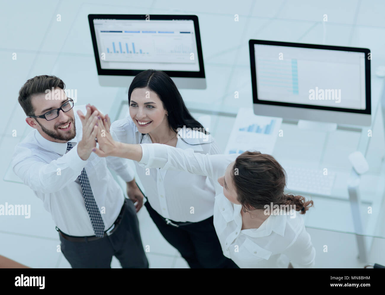 successful business team giving each other a high five Stock Photo - Alamy
