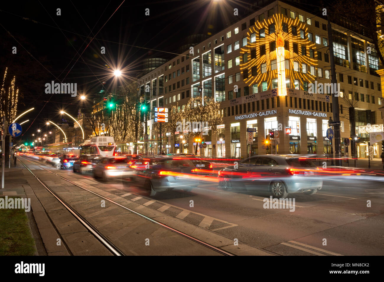 Nightly traffic on Kärntner Ring with car light trails at Ringstraßen-Galerien. Stock Photo