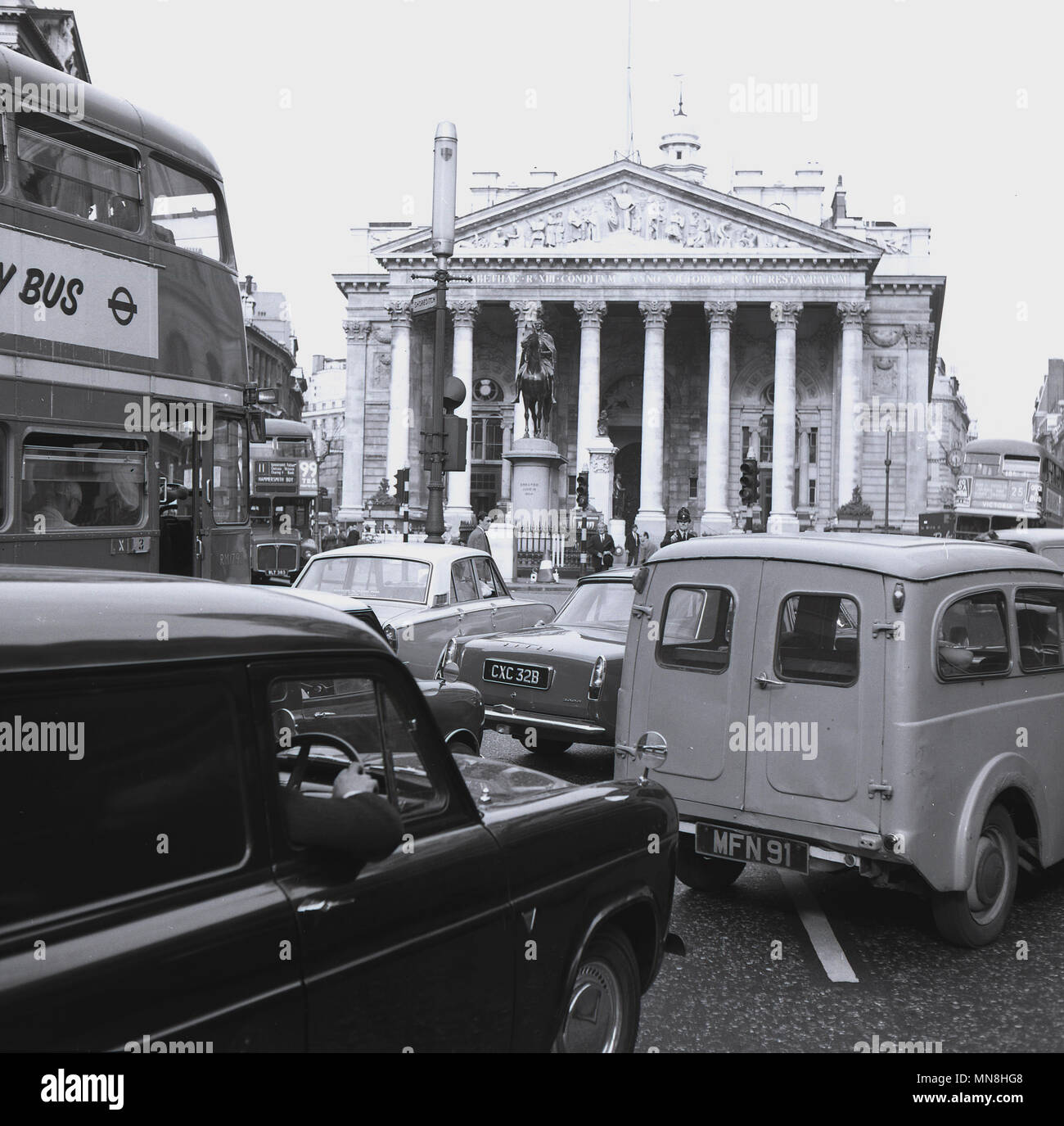 1960s, heavy vehicle traffic outside the Mansion House building in the City of London, England, UK. Stock Photo