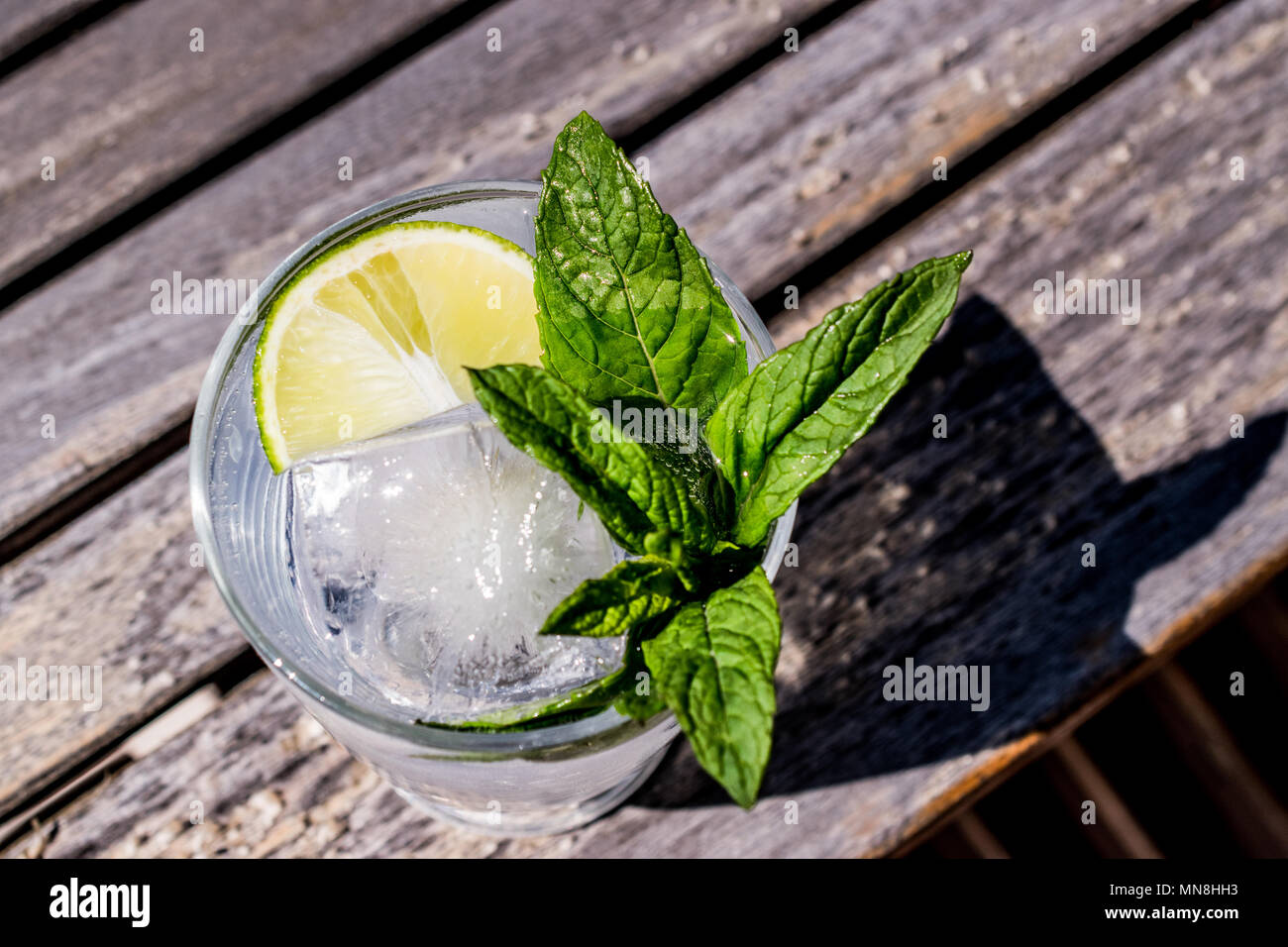 Vodka or Gin Tonic Cocktail with lime, mint leaves and ice at the